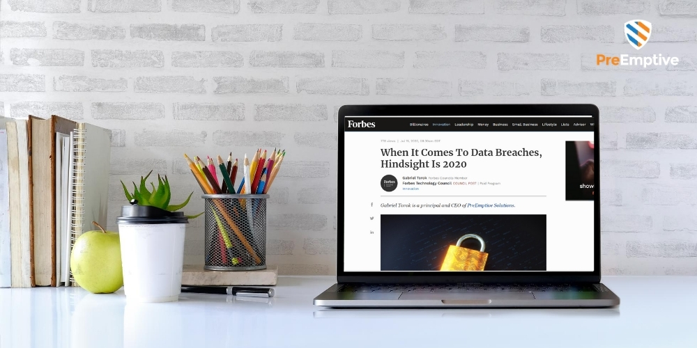laptop showing Forbes article about data breaches